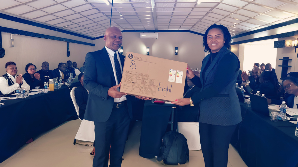 Dr Loveness Chimuka, Team Leader at edt in Zimbabwe, officially handing over desktop computers to Moses Mhike, Permanent Secretary for the Ministry of Primary and Secondary Education